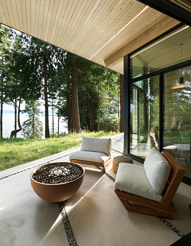 Modern fire bowl with comfortable seats over large paving stones and gravel. Credit to House & Home.