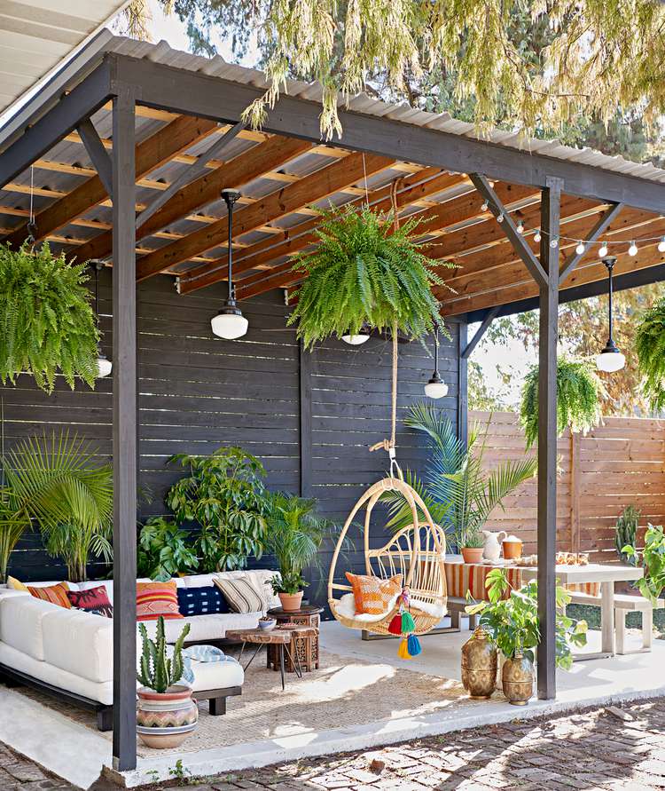 Modern pergola with a concrete foundation and pale furniture. Credit to Better Homes & Gardens